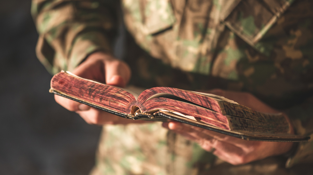 Army officer Michael Jones reads Today in the Word's daily devotional while stationed abroad